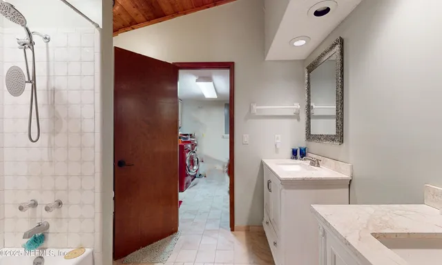 a bedroom with two bed and a flat screen tv