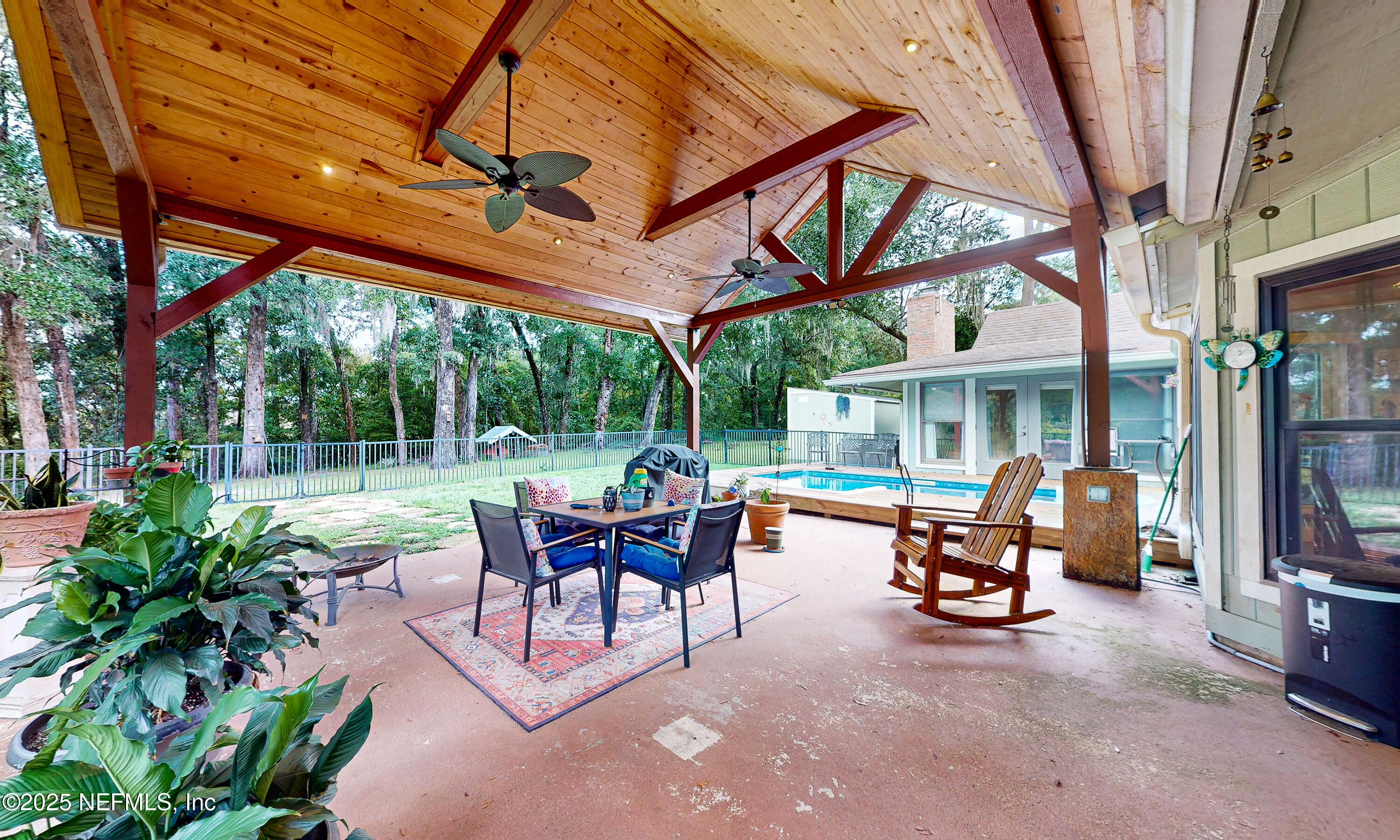 2860 Ravines Road Middleburg, FL 32068 - Photo 3 of 52 a view of a patio with a table and chairs under an umbrella
