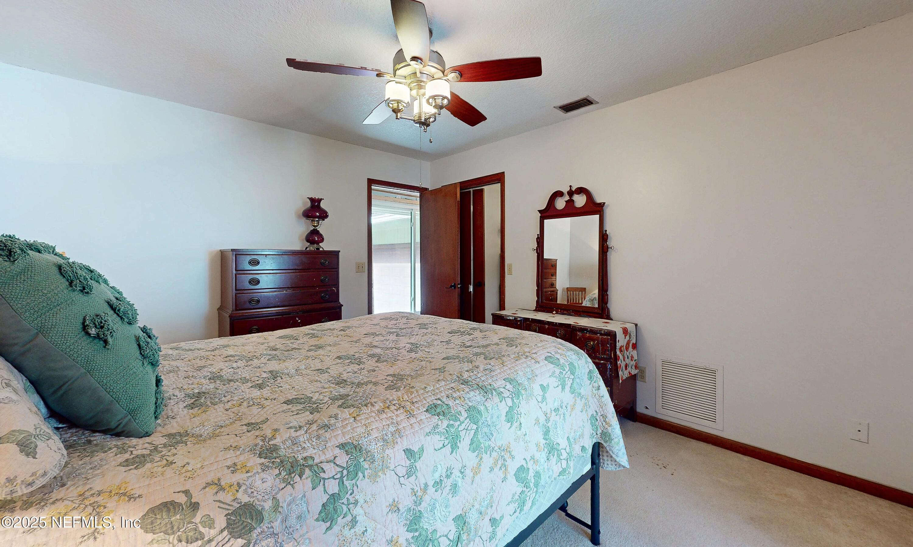 2860 Ravines Road Middleburg, FL 32068 - Photo 32 of 52 a bedroom with a bed and a chandelier