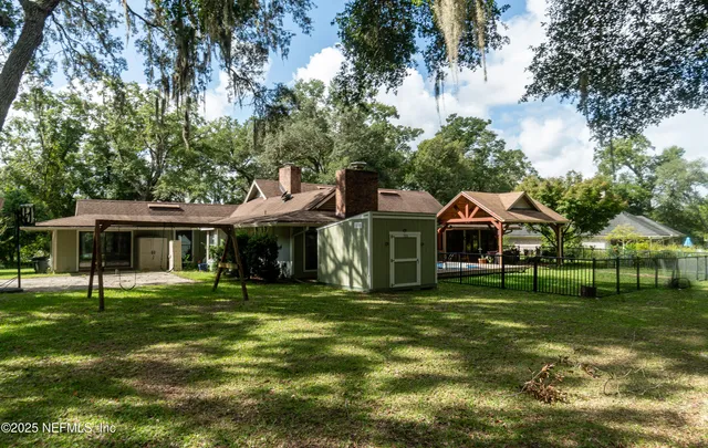 a view of backyard with trampoline