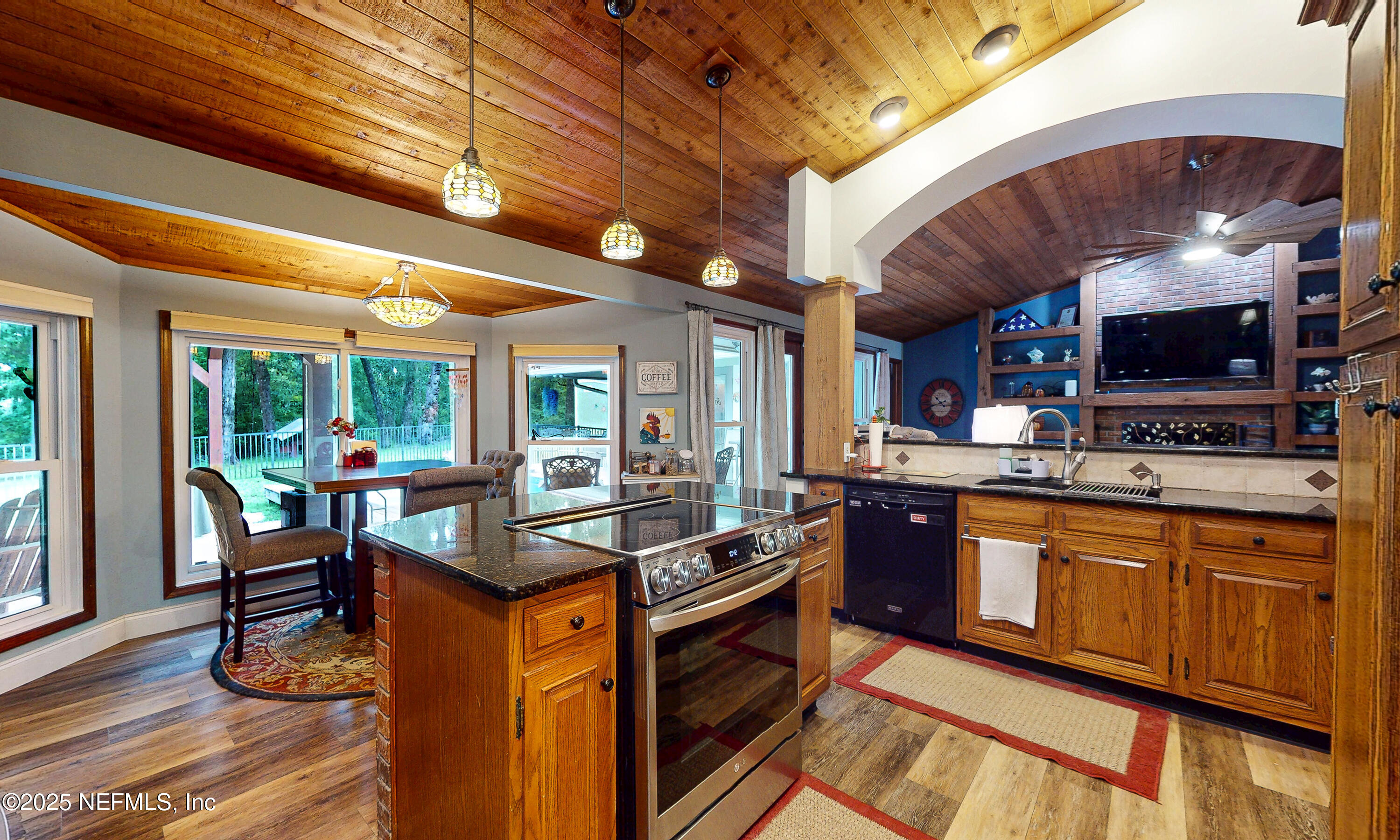 2860 Ravines Road Middleburg, FL 32068 - Photo 10 of 52 a kitchen with stainless steel appliances granite countertop a stove and a wooden cabinets