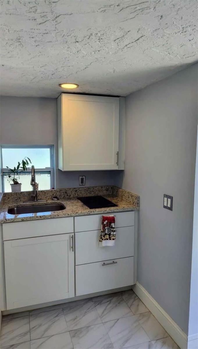 173 West 16th Street, Unit B Riviera Beach, FL 33404 - Photo 3 of 10 a stove top oven sitting inside of a kitchen