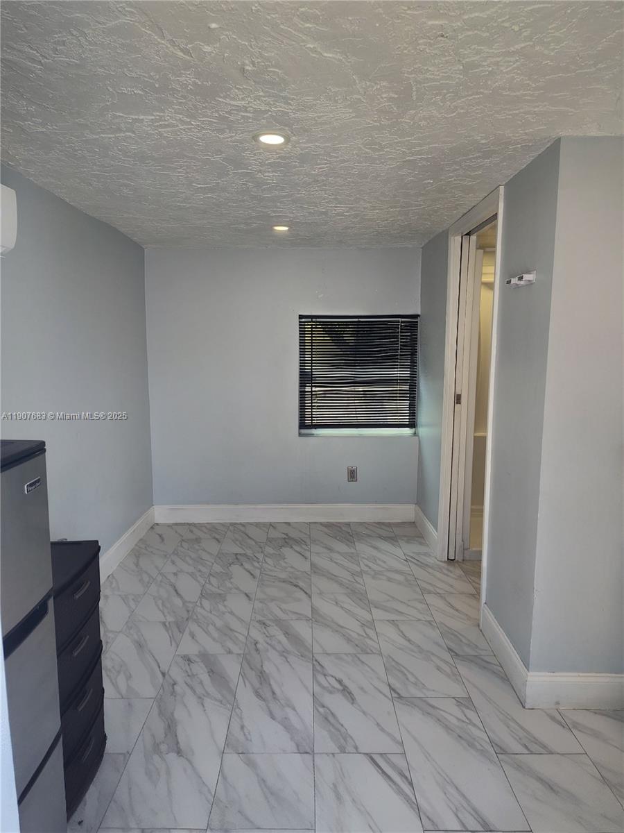 173 West 16th Street, Unit B Riviera Beach, FL 33404 - Photo 8 of 10 a view of empty room with a fireplace