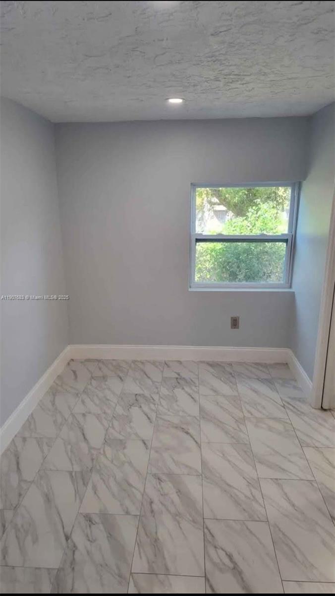 173 West 16th Street, Unit B Riviera Beach, FL 33404 - Photo 9 of 10 a view of empty room with window