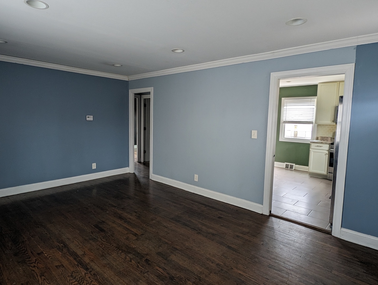 420 South Reed Street Joliet, IL 60436 - Photo 3 of 20 a view of an empty room with wooden floor and a window