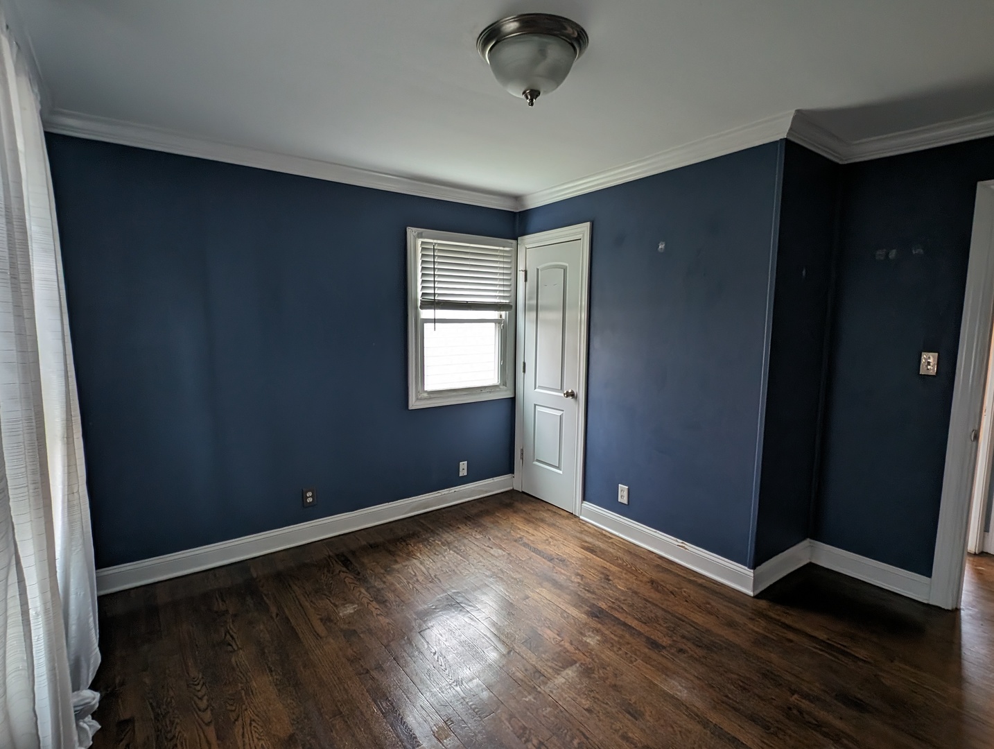 420 South Reed Street Joliet, IL 60436 - Photo 5 of 20 an empty room with wooden floor and windows