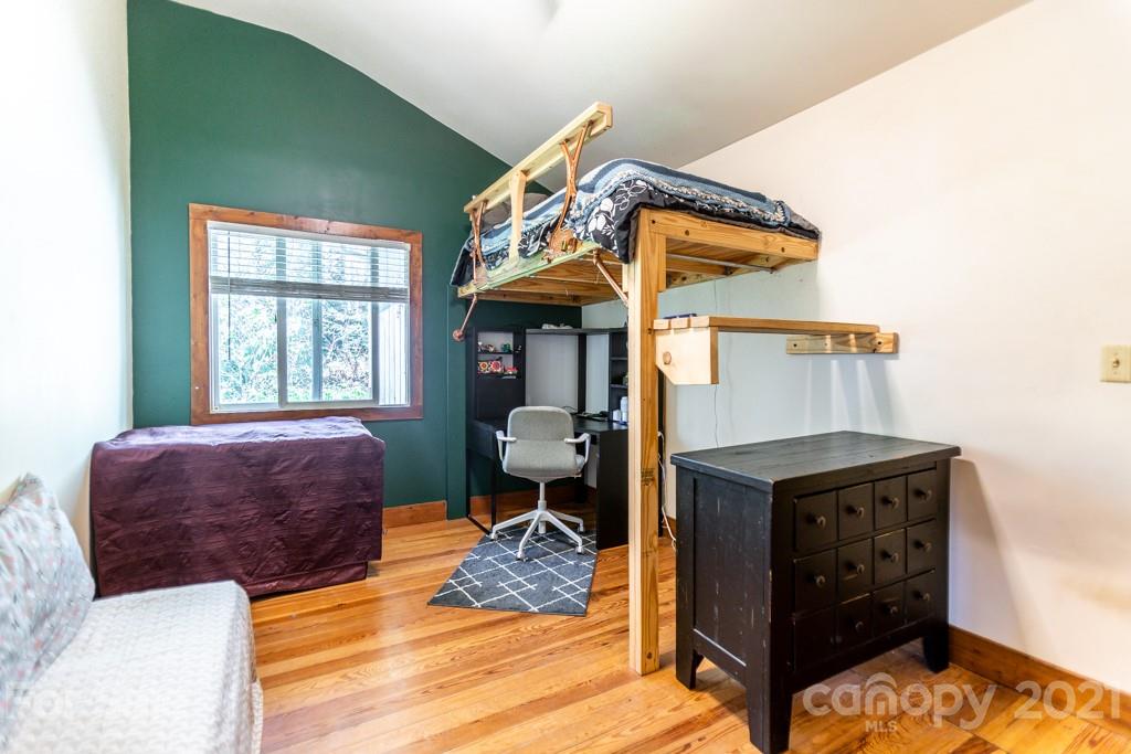 741 County Road Waynesville, NC 28785 - Photo 18 of 42 a bedroom with a bed and wooden floor