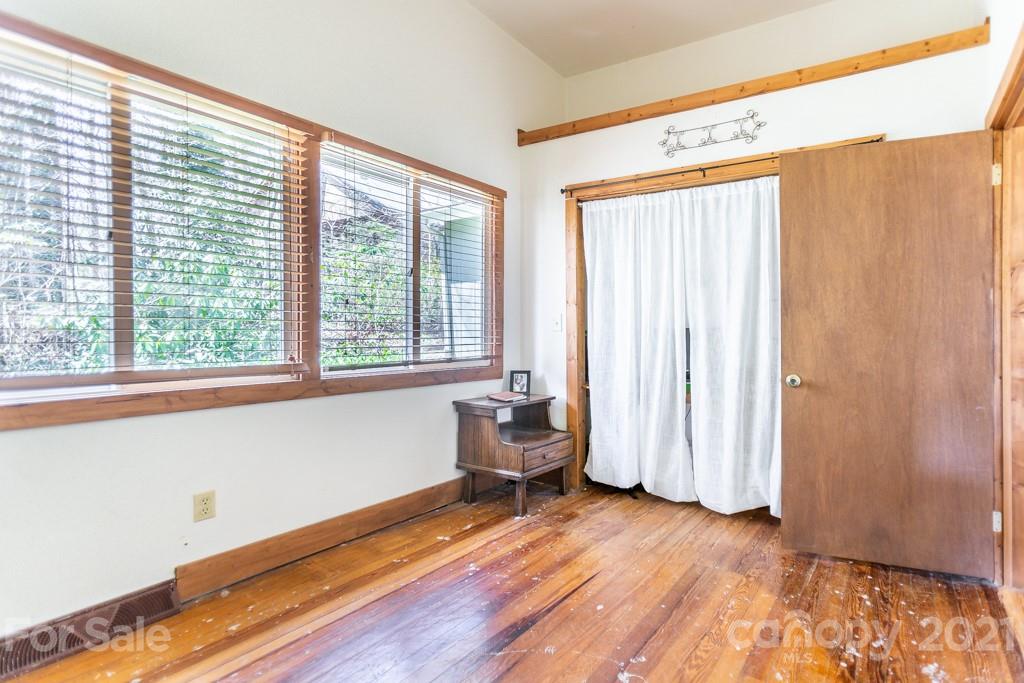 741 County Road Waynesville, NC 28785 - Photo 20 of 42 a view of an empty room with a window and wooden floor