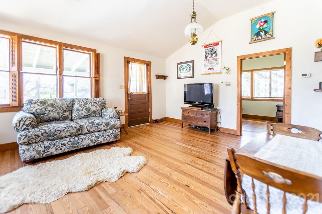 741 County Road Waynesville, NC 28785 - Photo 3 of 42 a living room with furniture large window wooden floor and a flat screen tv