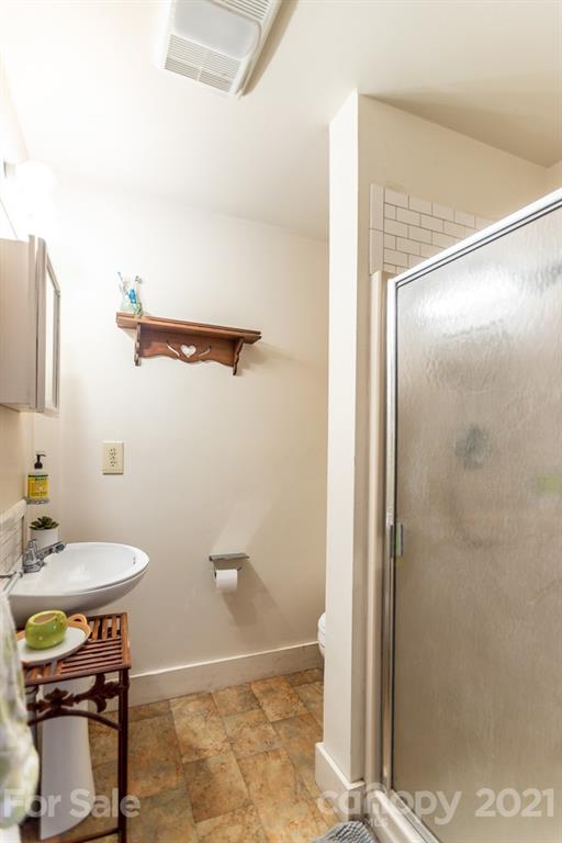 741 County Road Waynesville, NC 28785 - Photo 21 of 42 a bathroom with a sink and a mirror
