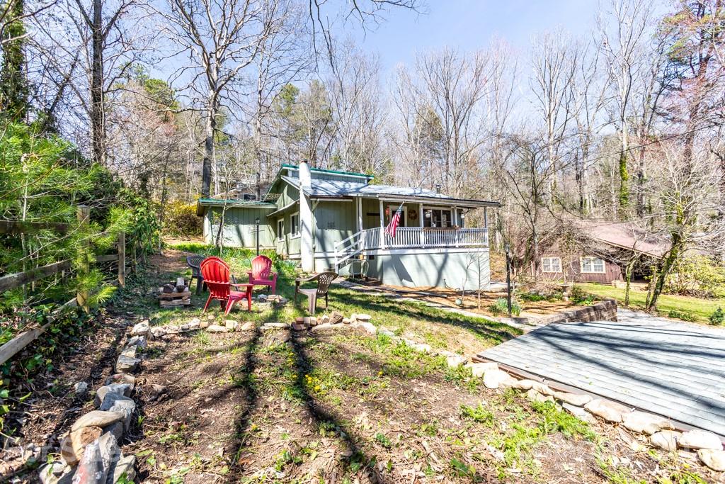 741 County Road Waynesville, NC 28785 - Photo 25 of 42 a view of a house with large trees and playing area