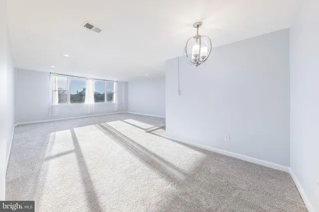 a view of kitchen and empty room
