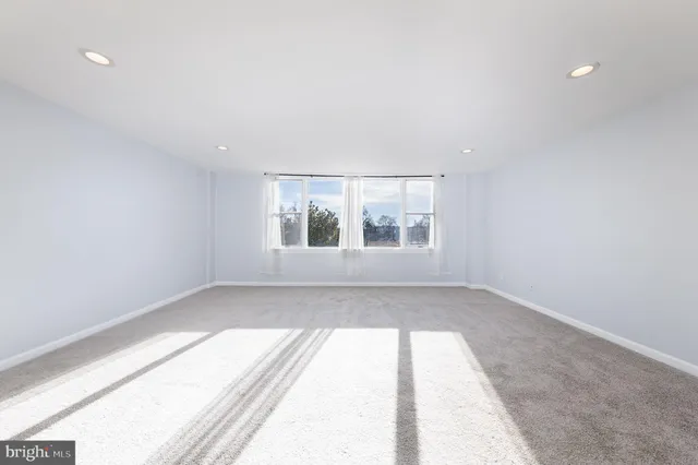 a view of a hallway with wooden shelves