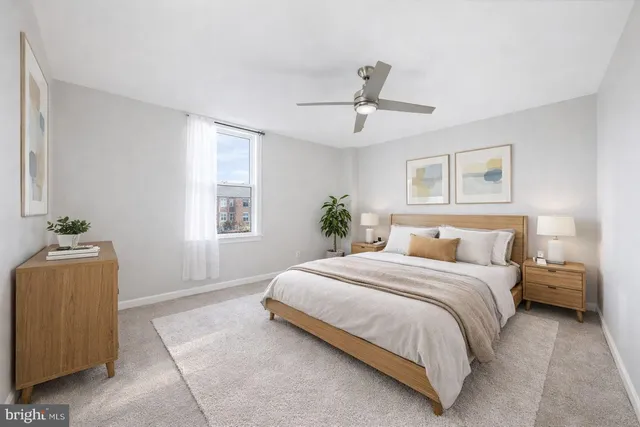 a bedroom with a bed and a potted plant