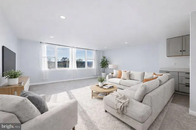 a living room with furniture and windows