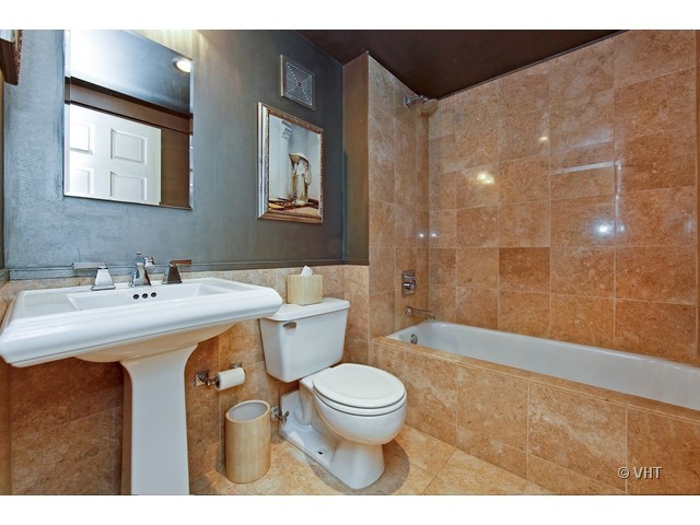 1000 West Washington Boulevard, Unit 428 Chicago, IL 60607 - Photo 14 of 16 a bathroom with a sink a toilet and shower