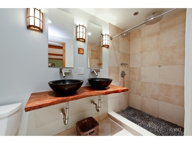 1000 West Washington Boulevard, Unit 428 Chicago, IL 60607 - Photo 9 of 16 a bathroom with a sink a toilet and shower
