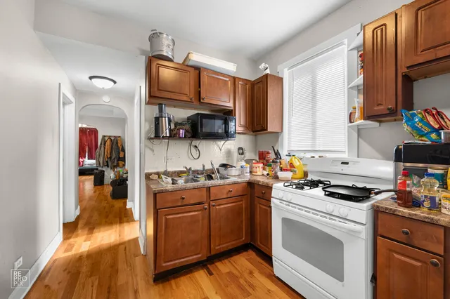 a kitchen with stainless steel appliances granite countertop a stove sink and cabinets