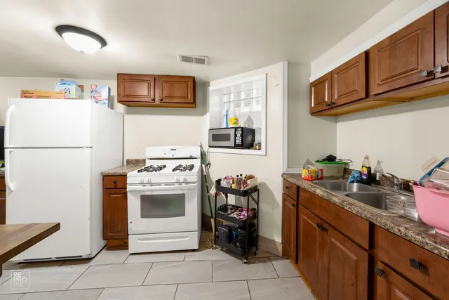 a kitchen with stainless steel appliances granite countertop a refrigerator stove a sink dishwasher and microwave oven