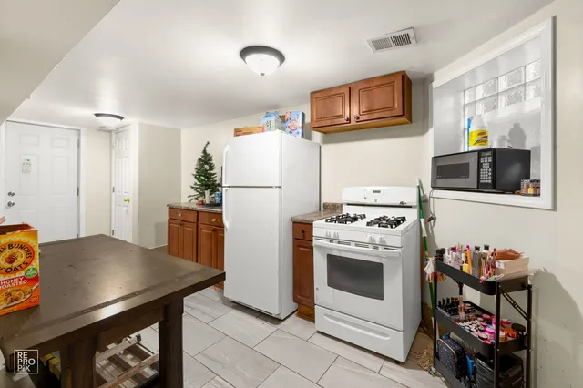 a kitchen with stainless steel appliances a stove a refrigerator and a sink