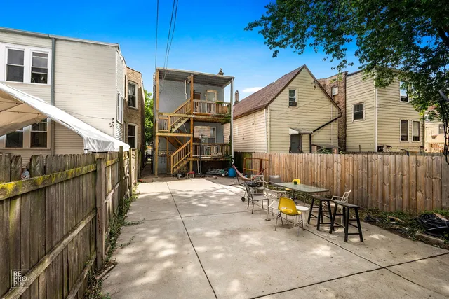 a view of a house with wooden fence