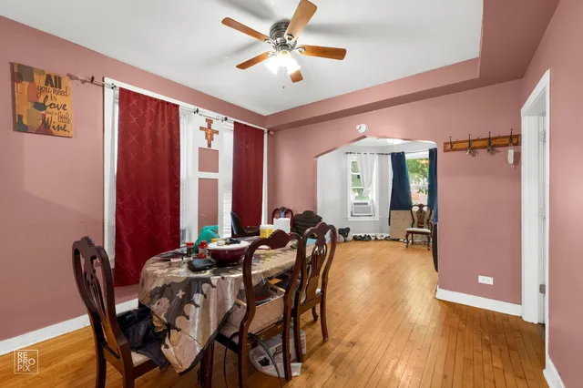 a view of a a dining room with furniture window and wooden floor