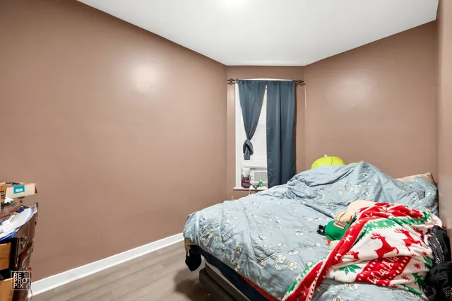 a bedroom with a bed and dresser