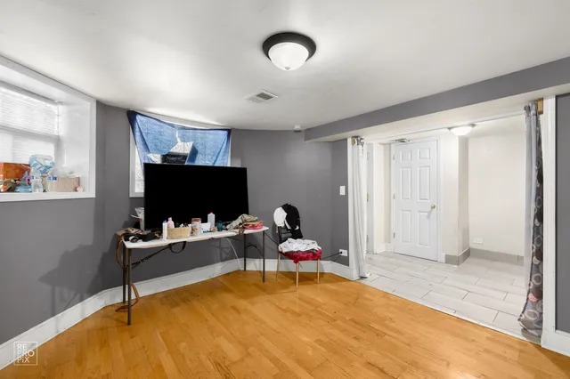 a bedroom with furniture and a flat screen tv