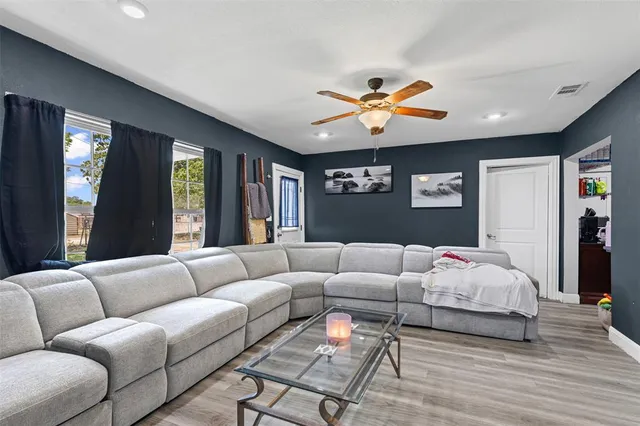 a living room with furniture ceiling fan and a rug