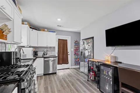 a view of kitchen with cabinets and wooden floor