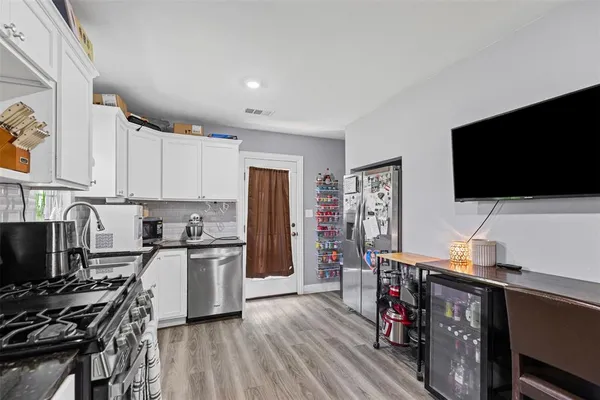 a view of kitchen with cabinets and wooden floor