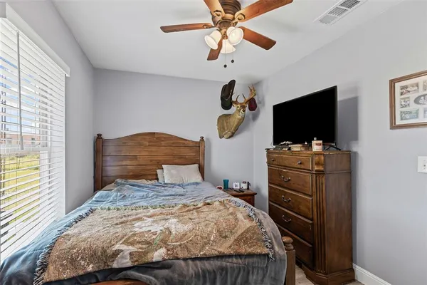 a bedroom with a bed and a flat tv screen