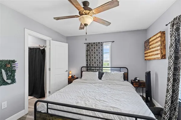 a bedroom with a bed and a chandelier