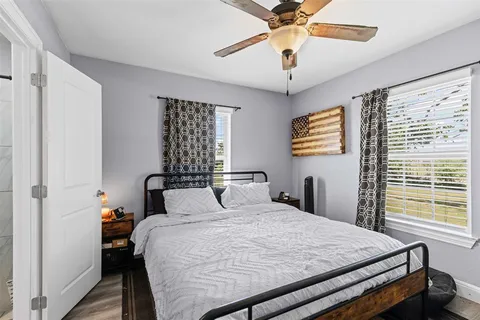 a bedroom with a large bed and a chandelier