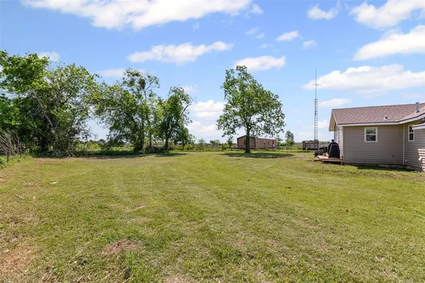 a view of a field with an trees