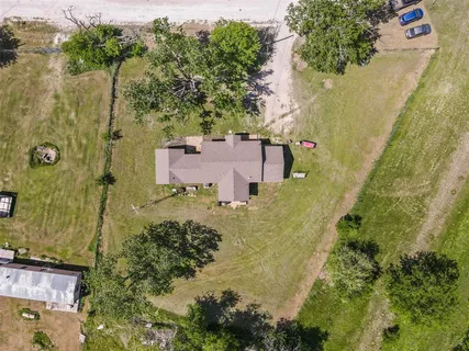 an aerial view of a house with a yard