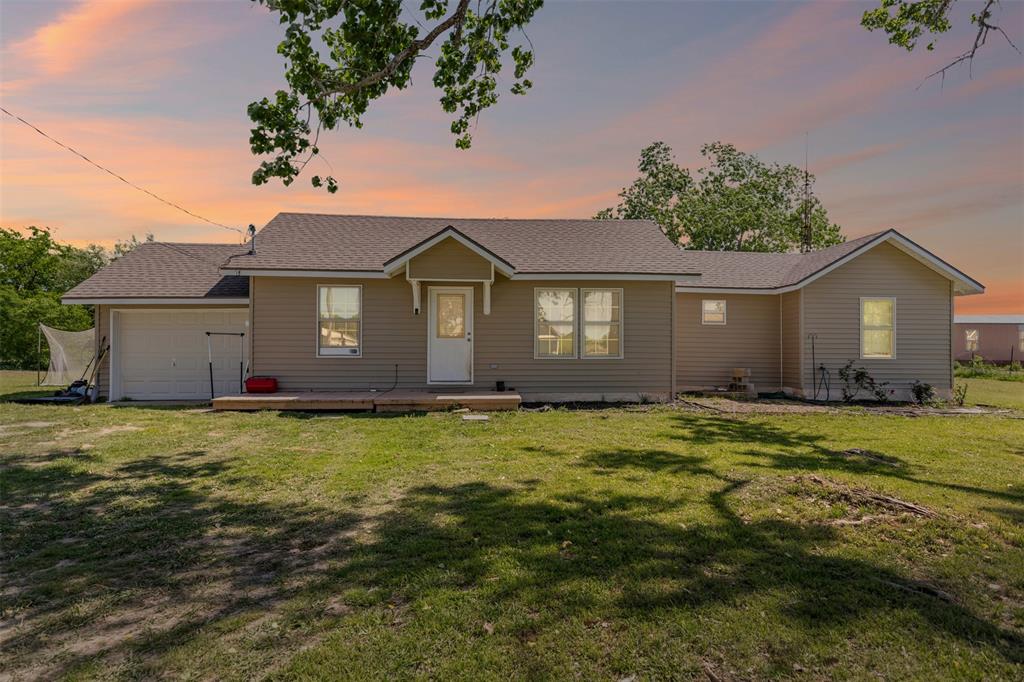105 South Lavaca Street Whitney, TX 76692 - Photo 4 of 40 a house view with a garden space