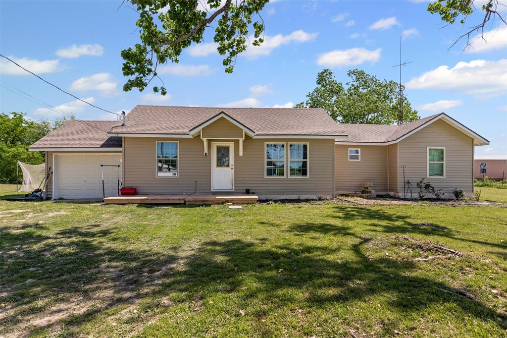 105 South Lavaca Street Whitney, TX 76692 - Photo 5 of 40 a view of a house with a backyard