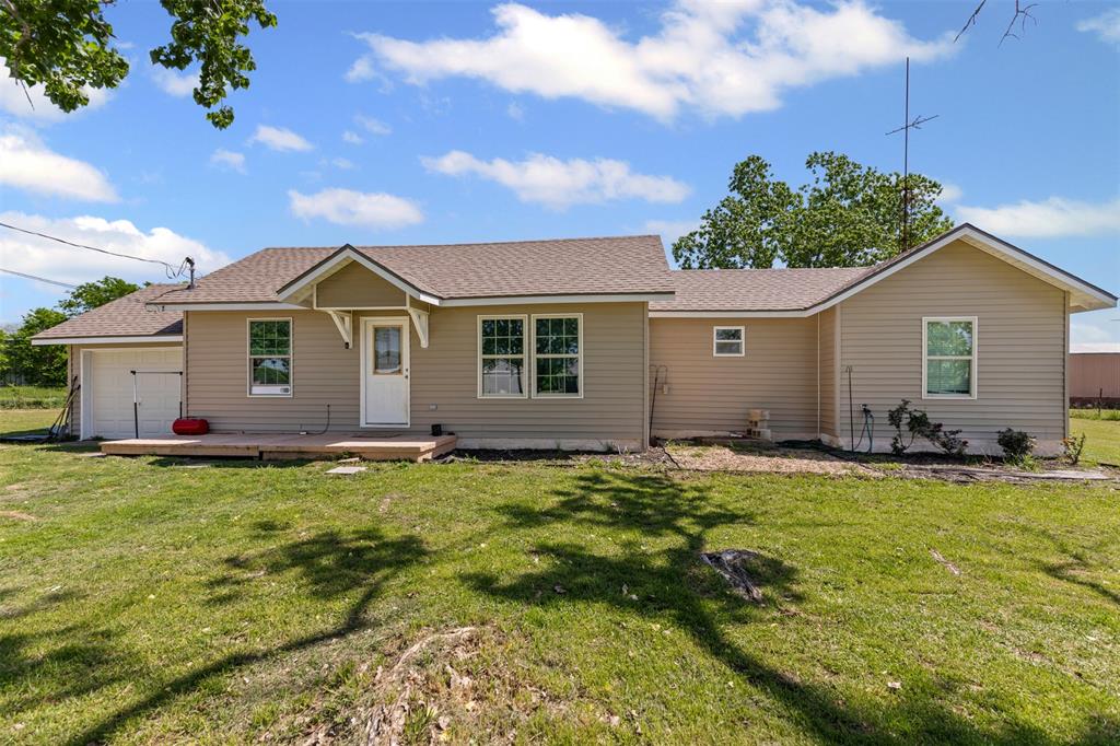 105 South Lavaca Street Whitney, TX 76692 - Photo 6 of 40 a view of a yard in front of a house with plants