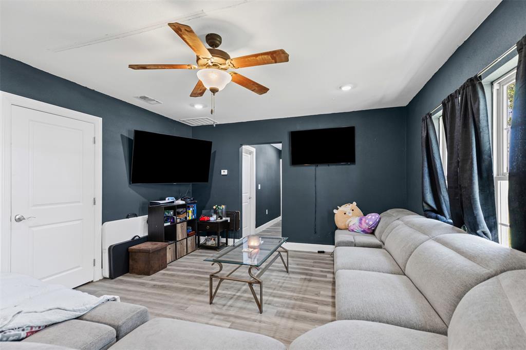 105 South Lavaca Street Whitney, TX 76692 - Photo 9 of 40 a living room with furniture and a flat screen tv