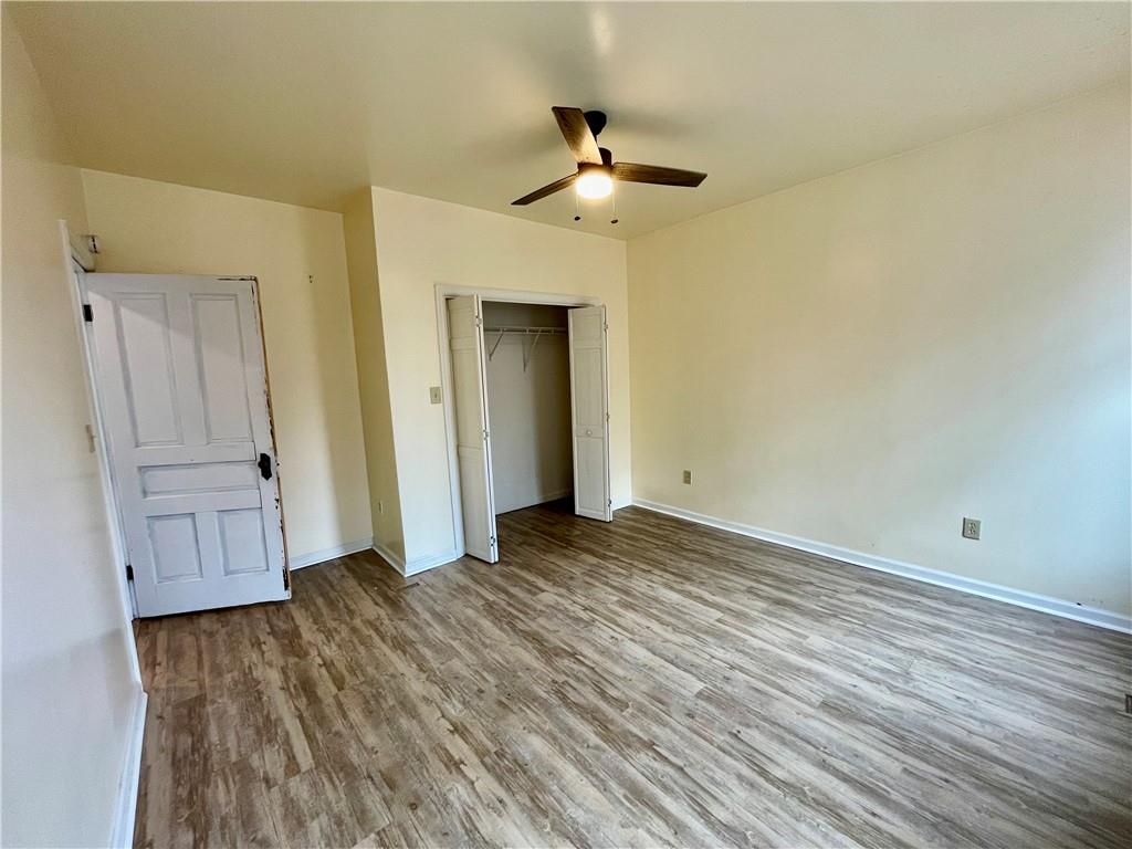 141 Overbeck Street Pittsburgh, PA 15212 - Photo 13 of 29 a view of a livingroom with wooden floor and ceiling fan