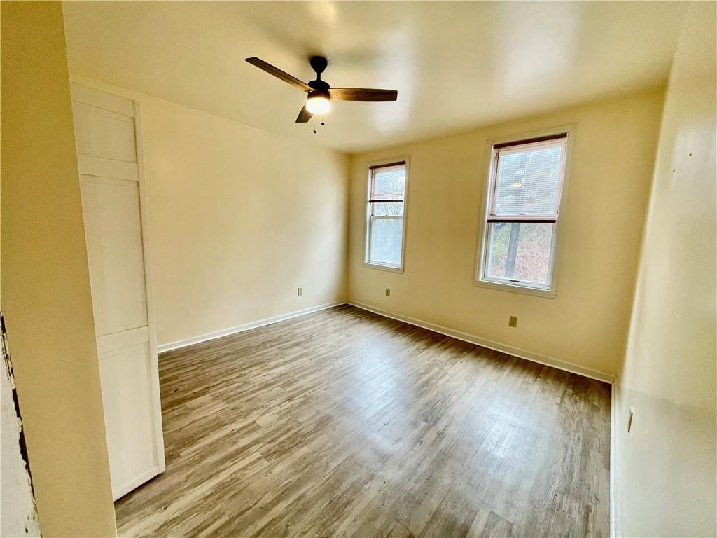 141 Overbeck Street Pittsburgh, PA 15212 - Photo 15 of 29 a view of an empty room with wooden floor and a window