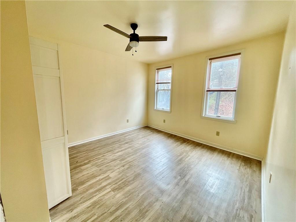 141 Overbeck Street Pittsburgh, PA 15212 - Photo 16 of 29 a view of a livingroom with wooden floor and a window