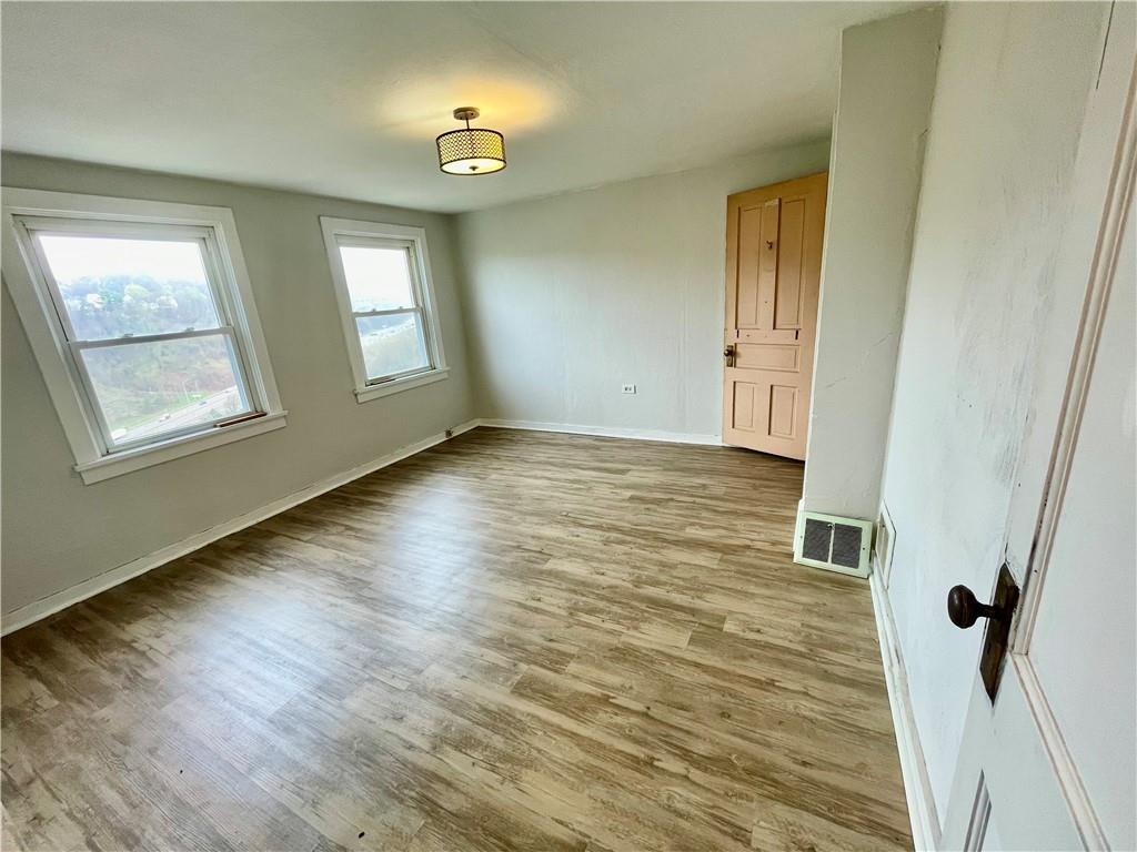 141 Overbeck Street Pittsburgh, PA 15212 - Photo 20 of 29 a view of a room with wooden floor and windows