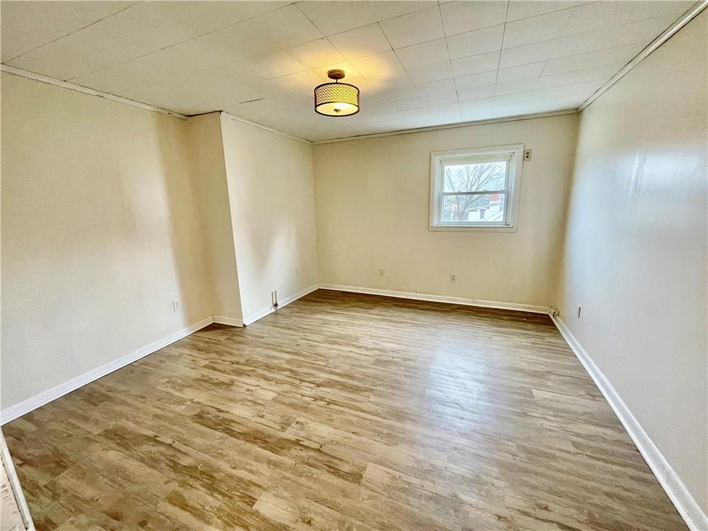 141 Overbeck Street Pittsburgh, PA 15212 - Photo 21 of 29 an empty room with wooden floor and windows