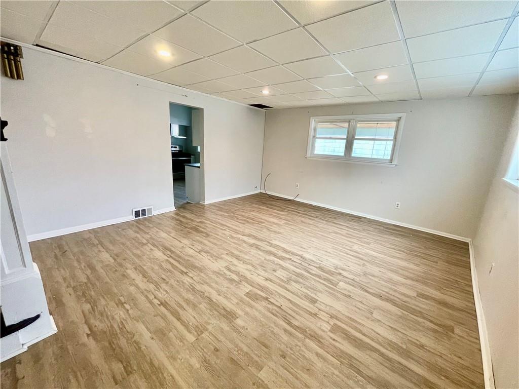 141 Overbeck Street Pittsburgh, PA 15212 - Photo 4 of 29 a view of an empty room with wooden floor and a window