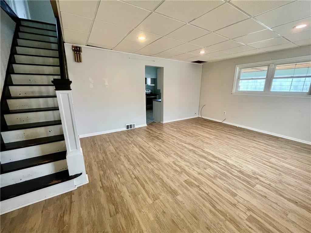 141 Overbeck Street Pittsburgh, PA 15212 - Photo 5 of 29 wooden floor in an empty room with a window