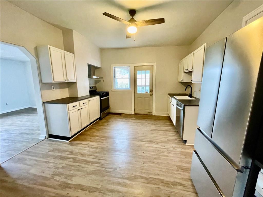 141 Overbeck Street Pittsburgh, PA 15212 - Photo 10 of 29 a kitchen with granite countertop a stove refrigerator and microwave