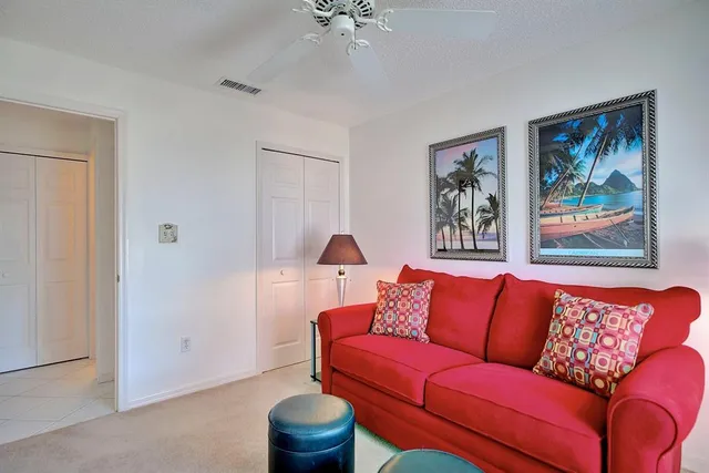 a blue couch sitting in a living room with a lamp