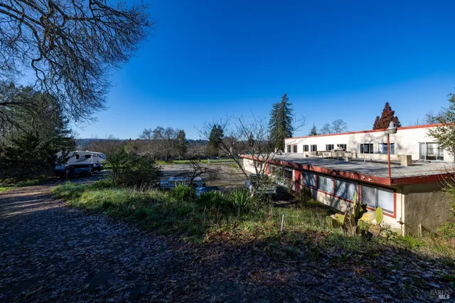 a living room with lots of furniture and a large window